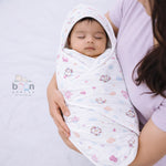 Boonbabies 2-layer muslin hooded baby towel with printed design, soft and absorbent, measuring 70x70 cm for newborns.