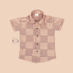 Pastel beige silk shirt with subtle golden checks, folded neatly beside a white veshti – premium boys’ ethnic shirt from Boon Babies, Coimbatore.