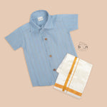 Sky blue silk shirt with gold thread stripes, paired with a white pattu dhoti – traditional festive wear set for boys by Boon Babies (ages 12M to 5Y).
