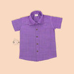 Violet silk shirt with gold vertical lines, folded beside white traditional veshti – boys' festive ethnicwear from Boon Babies, Coimbatore.