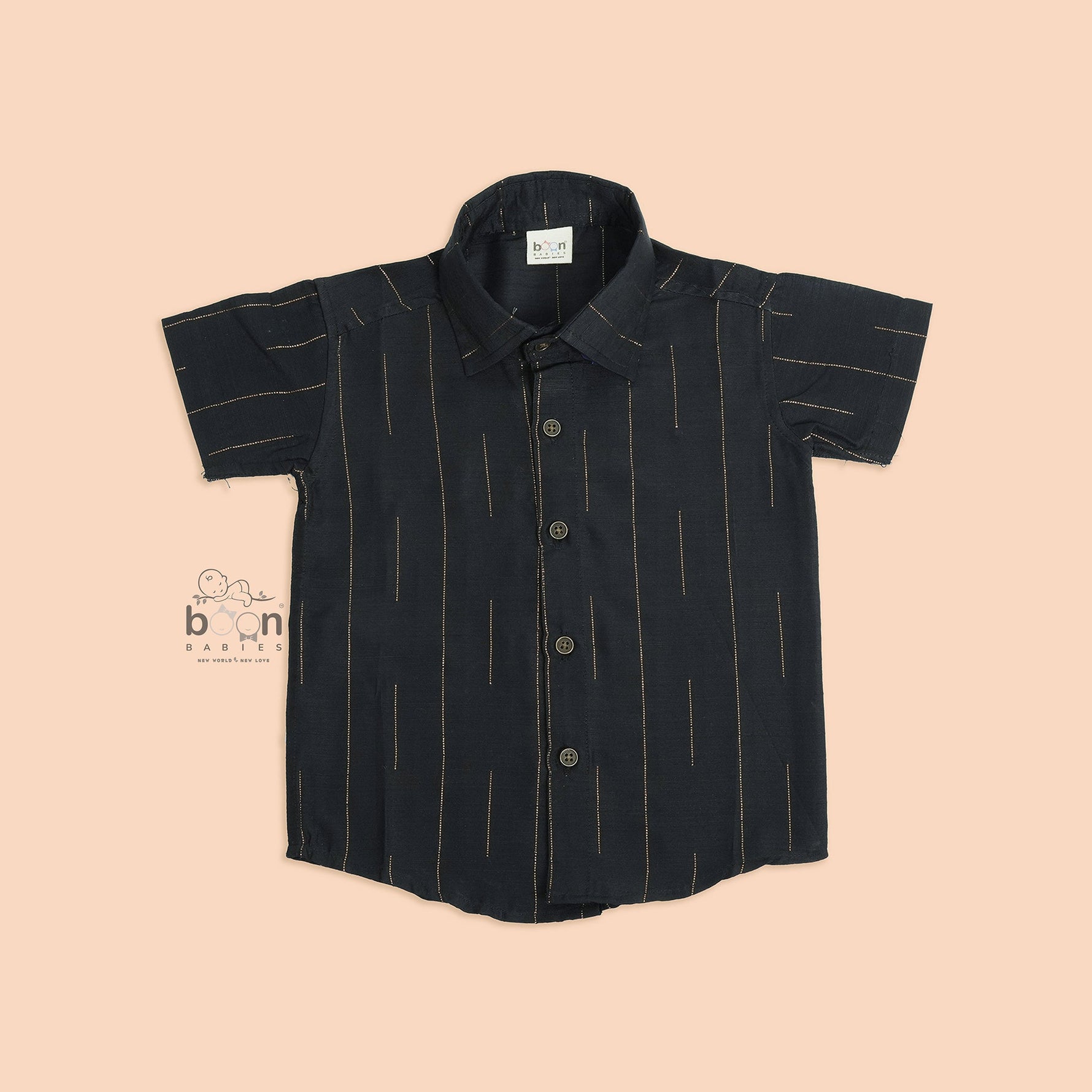 Folded black silk shirt with golden vertical lines, paired with traditional white veshti – premium ethnicwear for boys by Boon Babies, Coimbatore.