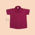 Boys magenta silk shirt neatly folded beside traditional white veshti – premium ethnicwear from Boon Babies.