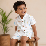 Boys wearing a printed cotton shirt with straight collar and matching shorts from Boon Babies in a casual outdoor setting