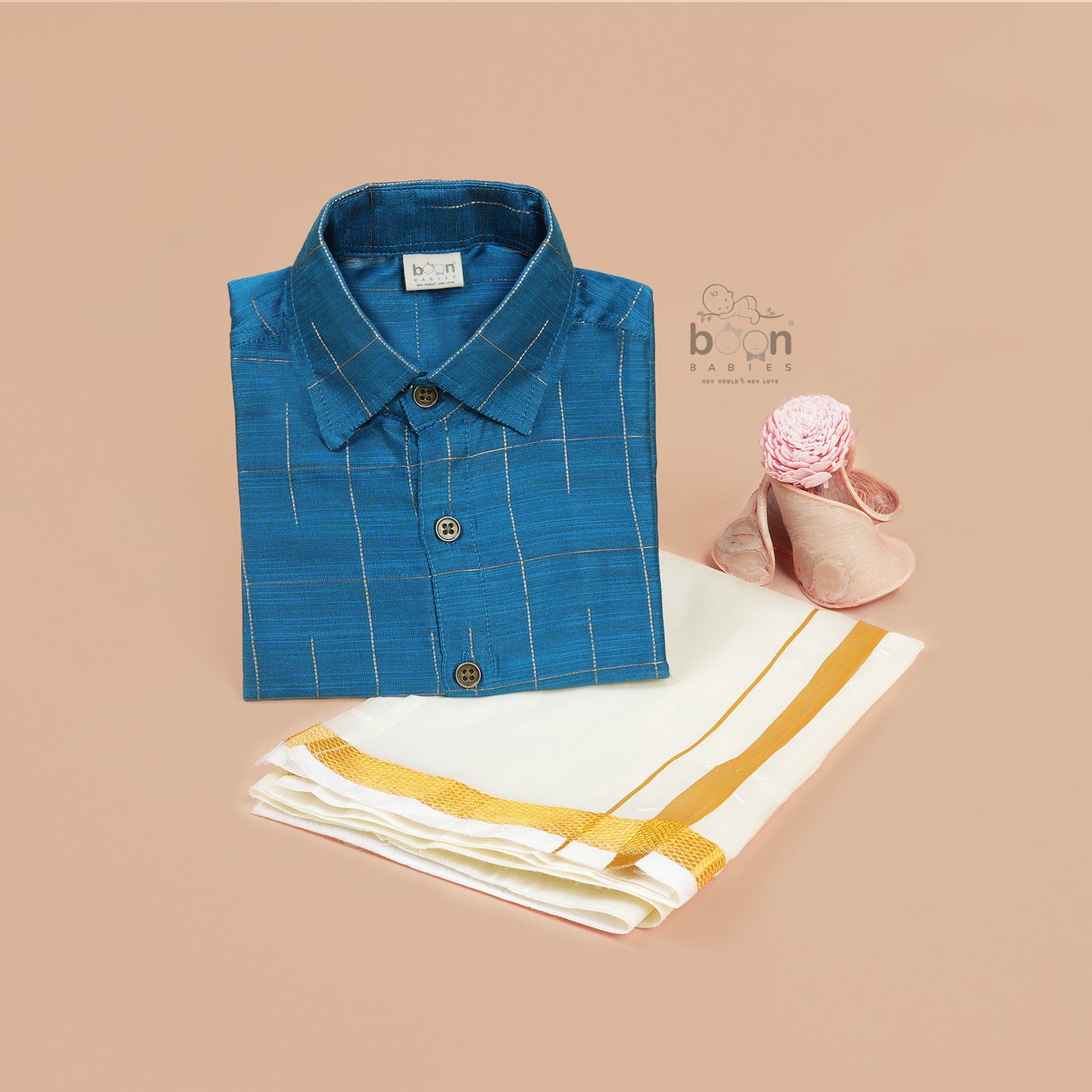 Boys festive outfit featuring a royal blue checked silk shirt and white dhoti with gold border – traditional South Indian attire by Boon Babies.