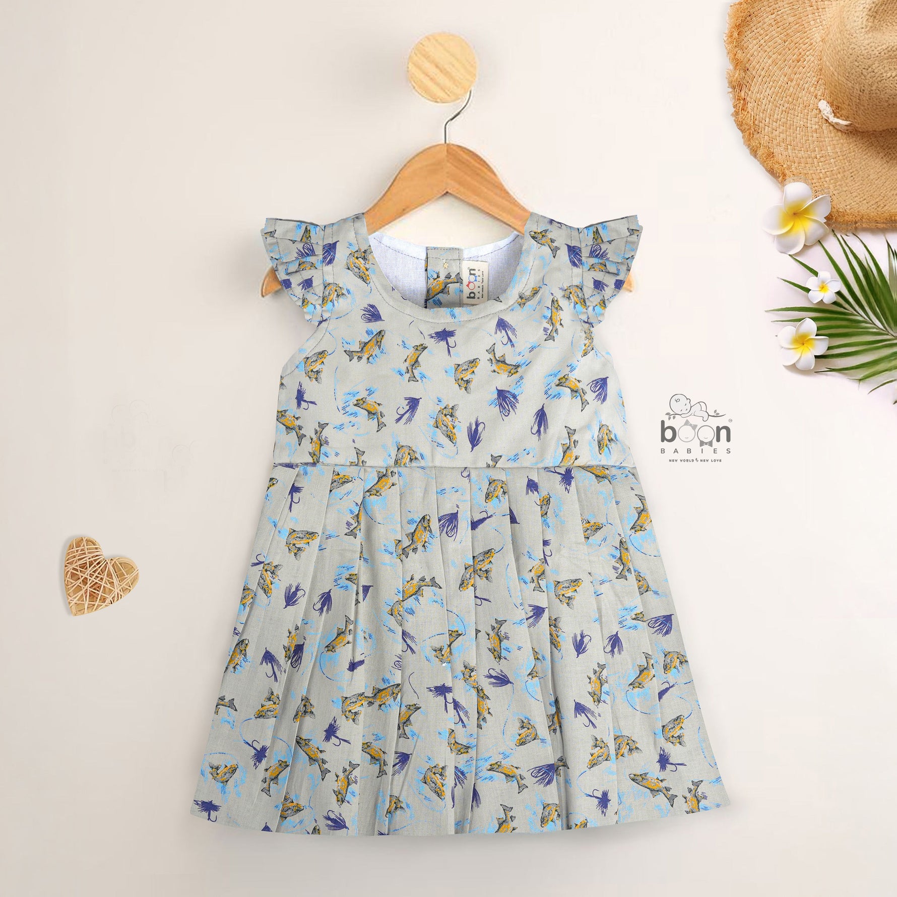 Blue floral cotton frock for girls with ruffle cap sleeves, designed for 6 months to 5 years – from Boon Babies kidswear collection, Coimbatore.