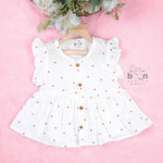 Pink crinkled muslin frill frock for baby girls by Boon Babies, featuring soft fabric and delicate frill detailing on the front.