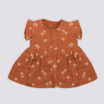 Brown crinkled muslin frill frock for baby girls by Boon Babies, featuring a playful print and delicate frill details.
