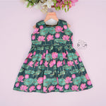 Sleeveless dark green frock for girls aged 1 to 4 years, featuring pink lotus floral print in slub cotton – from Boon Babies, Coimbatore.