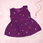 Baby girl wearing a purple ethnic sleeveless frock by Boon Babies, featuring traditional design and soft fabric.