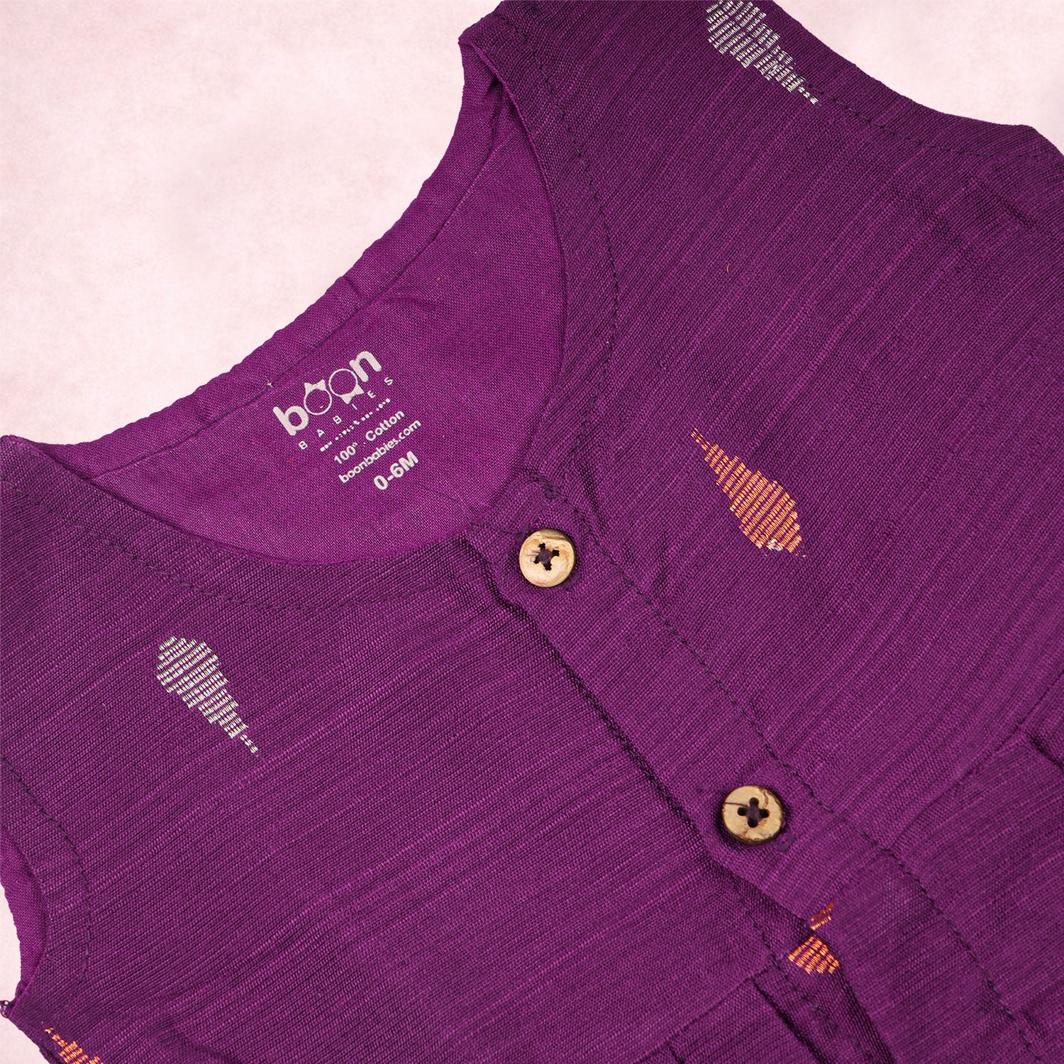Baby girl wearing a purple ethnic sleeveless frock by Boon Babies, showcasing traditional style and comfortable fit.