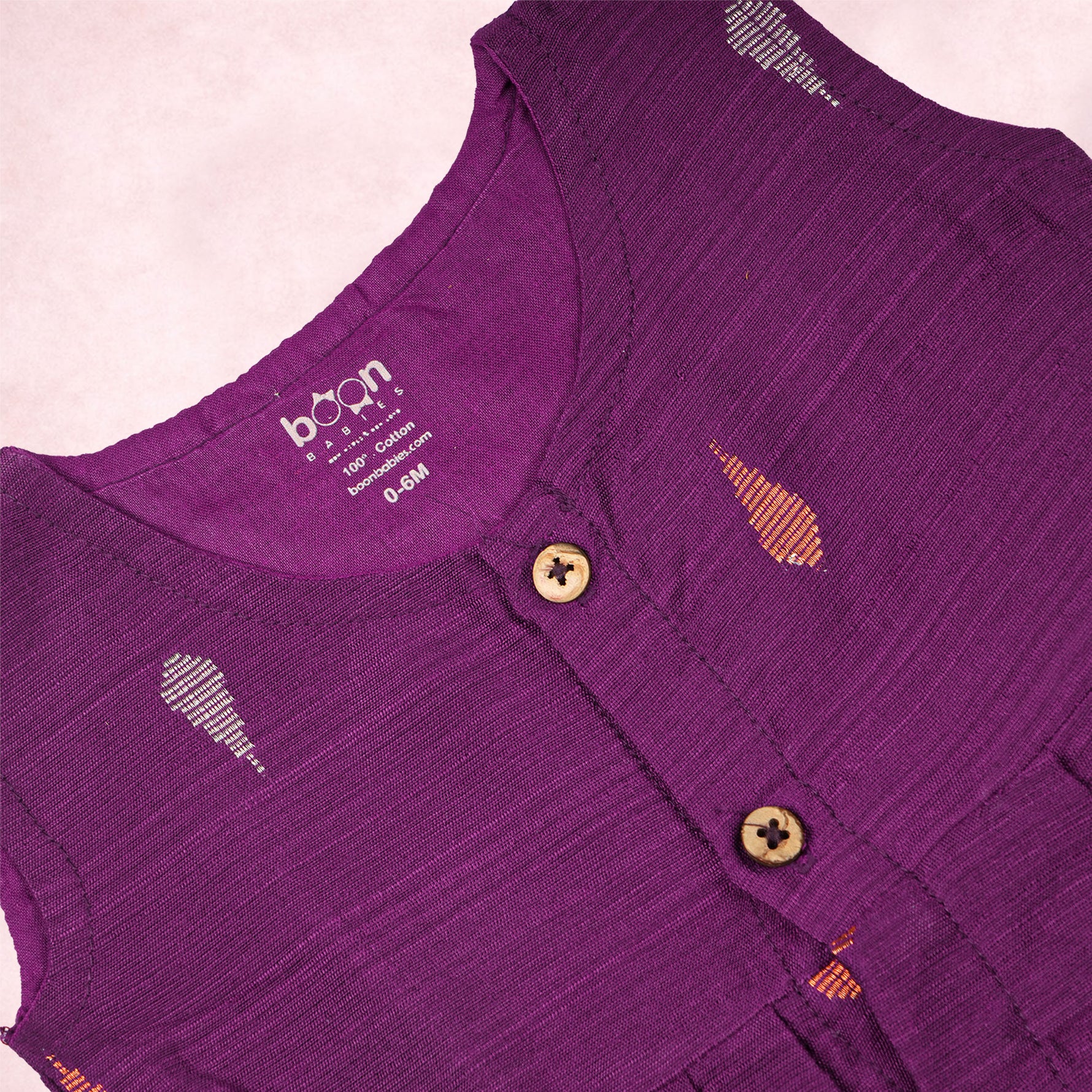 Baby girl wearing a purple ethnic sleeveless frock by Boon Babies, showcasing traditional style and comfortable fit.