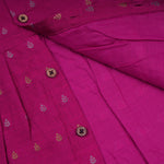 Baby girl in a Magenta Pink ethnic sleeveless frock by Boon Babies, showcasing the dress's vibrant color and traditional style.