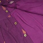 Baby girl wearing a purple Boon Babies ethnic sleeveless frock, showcasing traditional style and vibrant fabric details.
