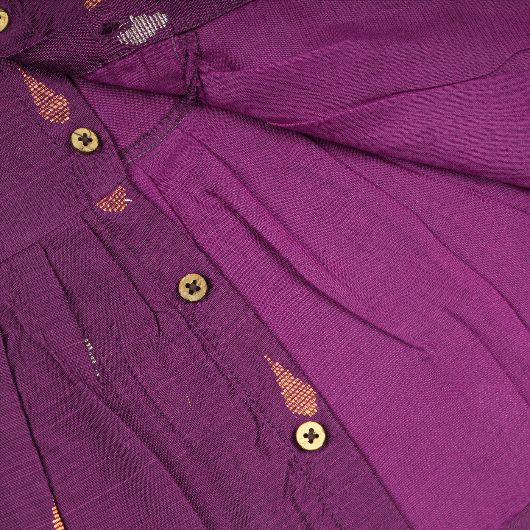 Baby girl wearing a purple Boon Babies ethnic sleeveless frock, showcasing traditional style and vibrant fabric details.
