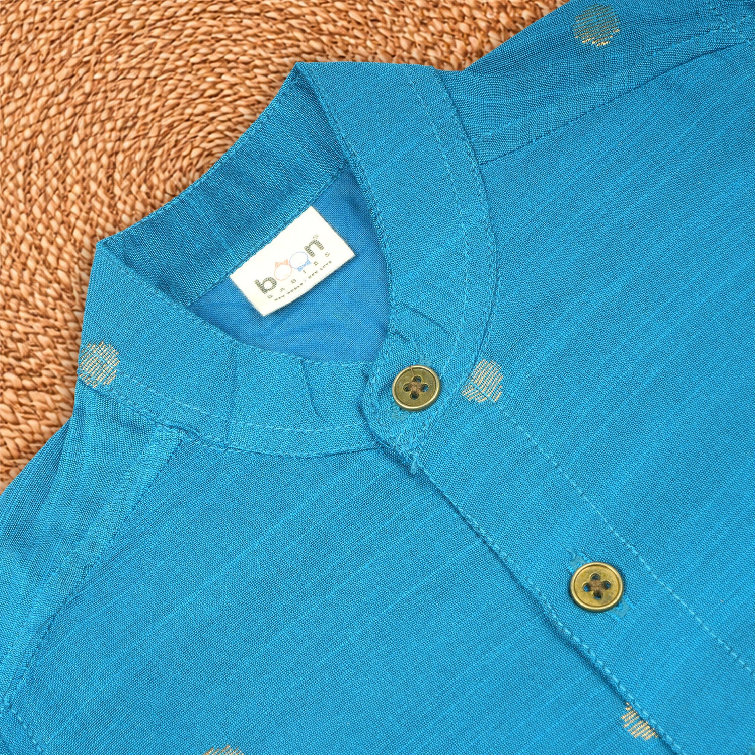 Boy wearing a sky blue silk butta traditional shirt and dhoti set by Booon Babies, perfect for festive ethnic celebrations.