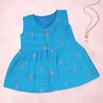 Baby girl wearing a blue ethnic sleeveless frock by Boon Babies, featuring traditional embroidery and comfortable fabric.