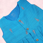 Baby girl wearing a blue ethnic sleeveless frock by Boon Babies, featuring traditional design and vibrant fabric.