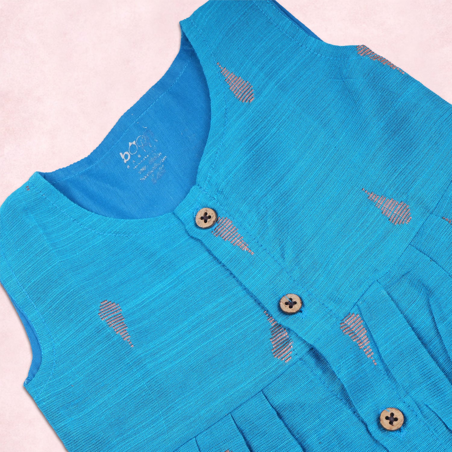 Baby girl wearing a blue ethnic sleeveless frock by Boon Babies, featuring traditional design and vibrant fabric.