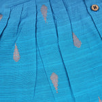 Baby girl in a blue ethnic sleeveless frock by Boon Babies, showcasing traditional style and soft fabric for special occasions.
