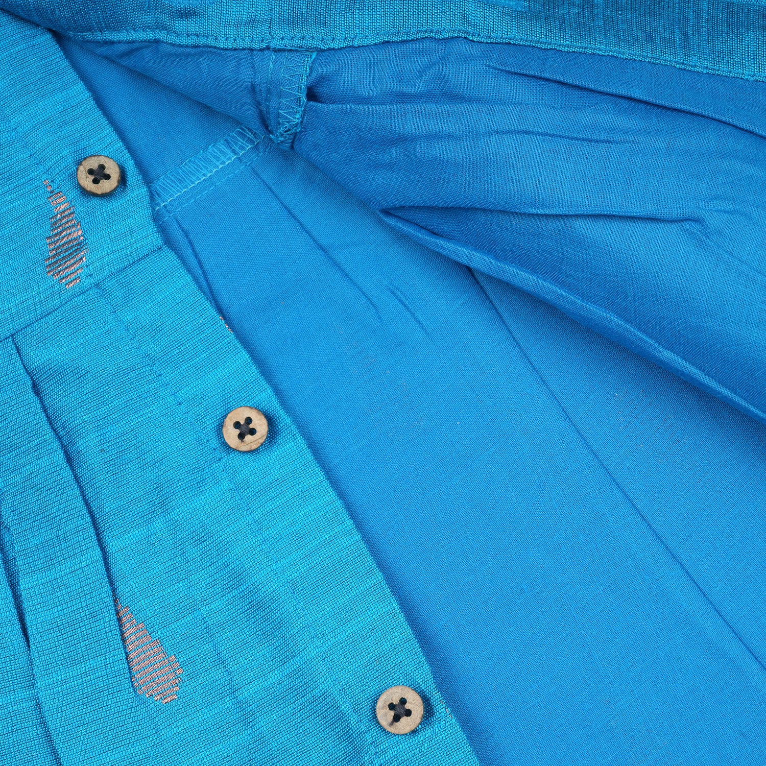 Baby girl wearing a blue ethnic sleeveless frock by Boon Babies, featuring traditional design and soft fabric.