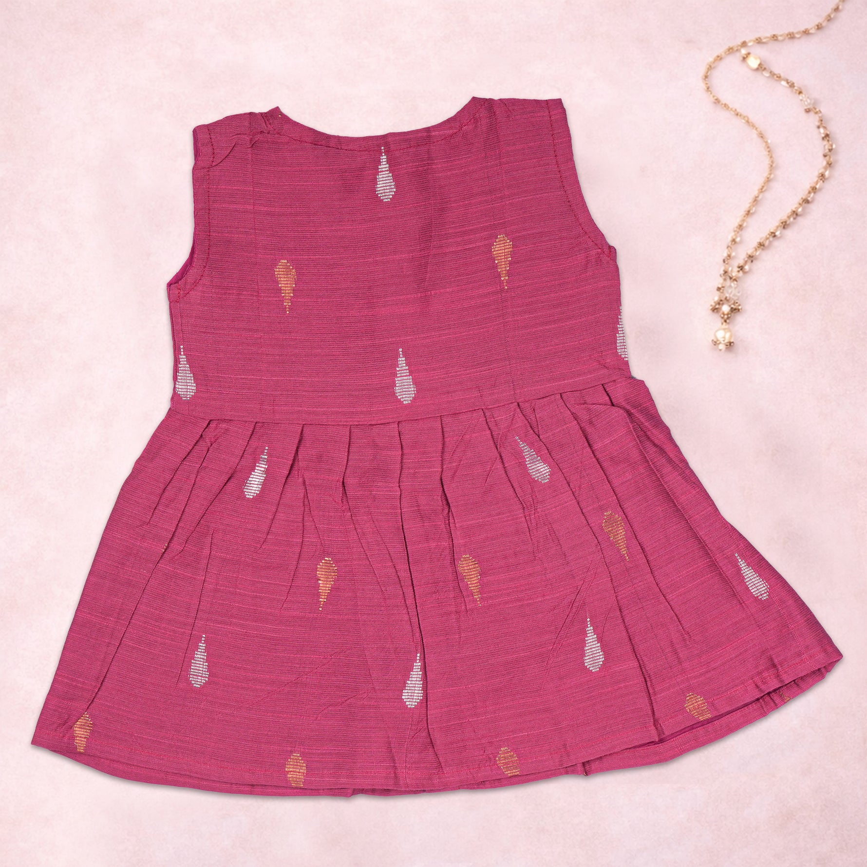 Baby girl wearing a pink ethnic sleeveless frock by Boon Babies, featuring intricate traditional embroidery and comfortable fabric.