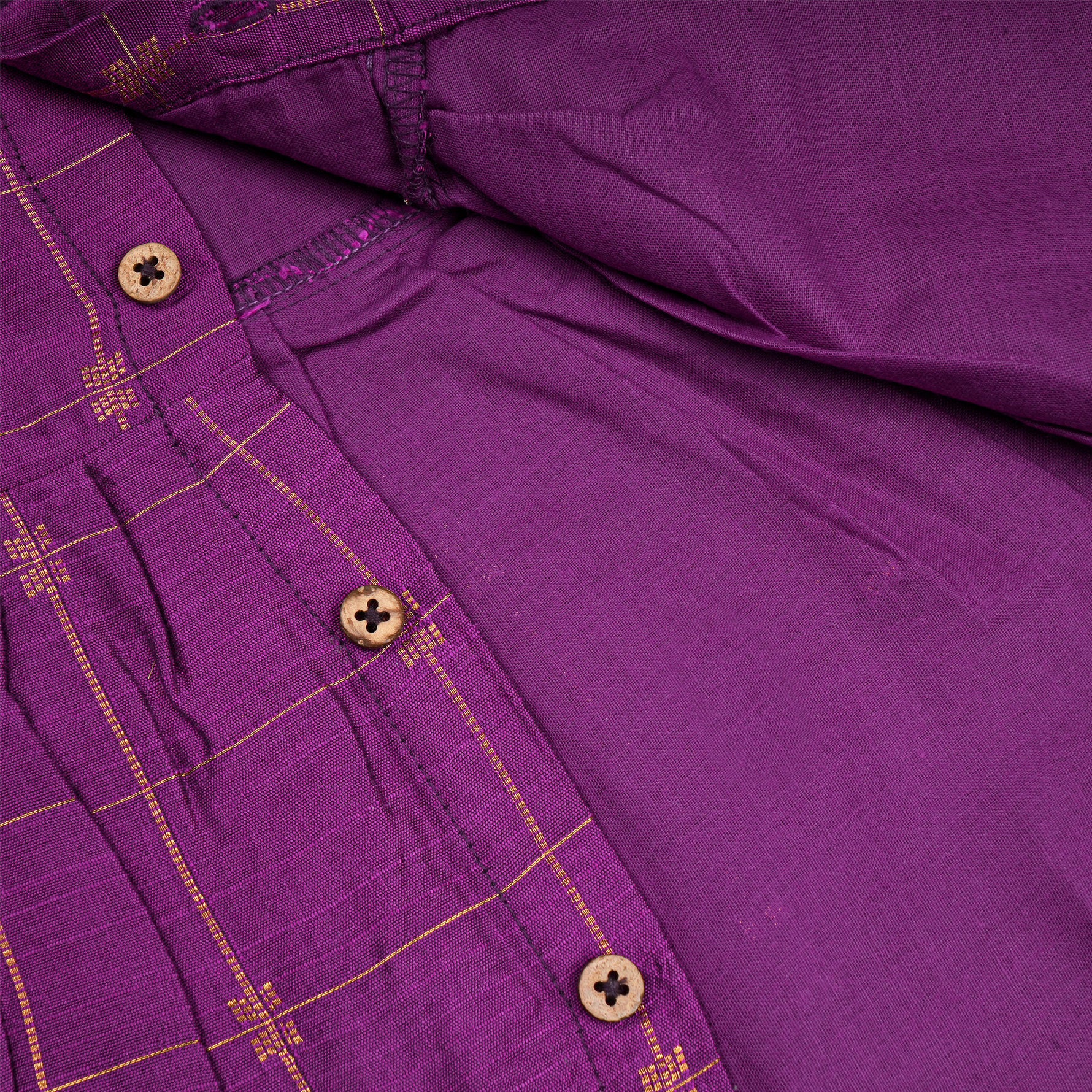 Baby girl wearing a purple ethnic sleeveless frock by Boon Babies, showcasing traditional style and vibrant fabric details.