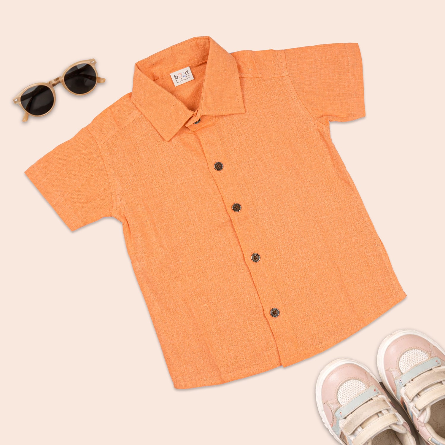 Boys' printed orange cotton shirt with straight collar, from Boon Babies, showcasing a vibrant, casual kids' clothing style.