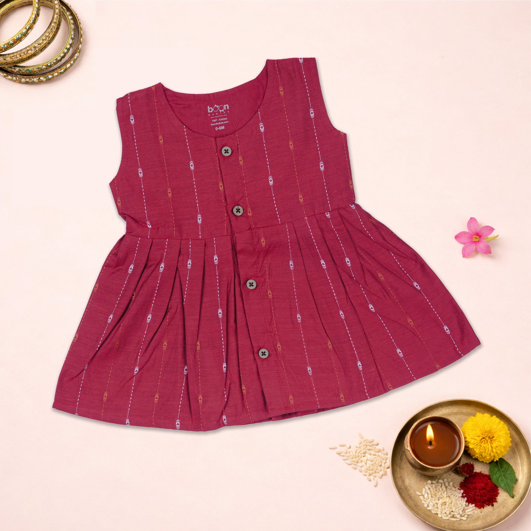 Baby girl wearing a cherry red ethnic sleeveless frock by Boon Babies, featuring traditional embroidery and a comfortable fit.