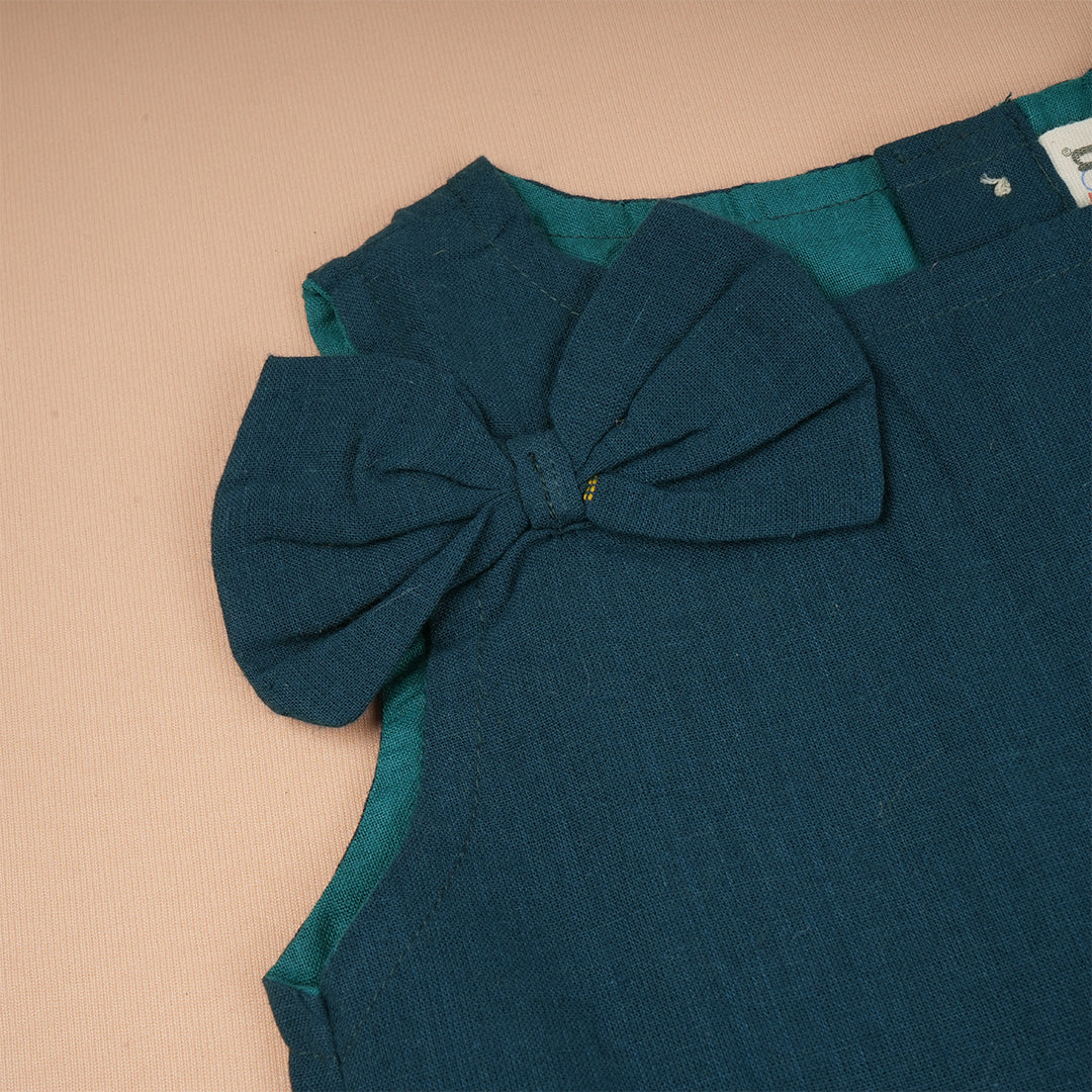 Girls teal green sleeveless co-ord set with matching pants by Boon Babies, shown in a casual outdoor setting.