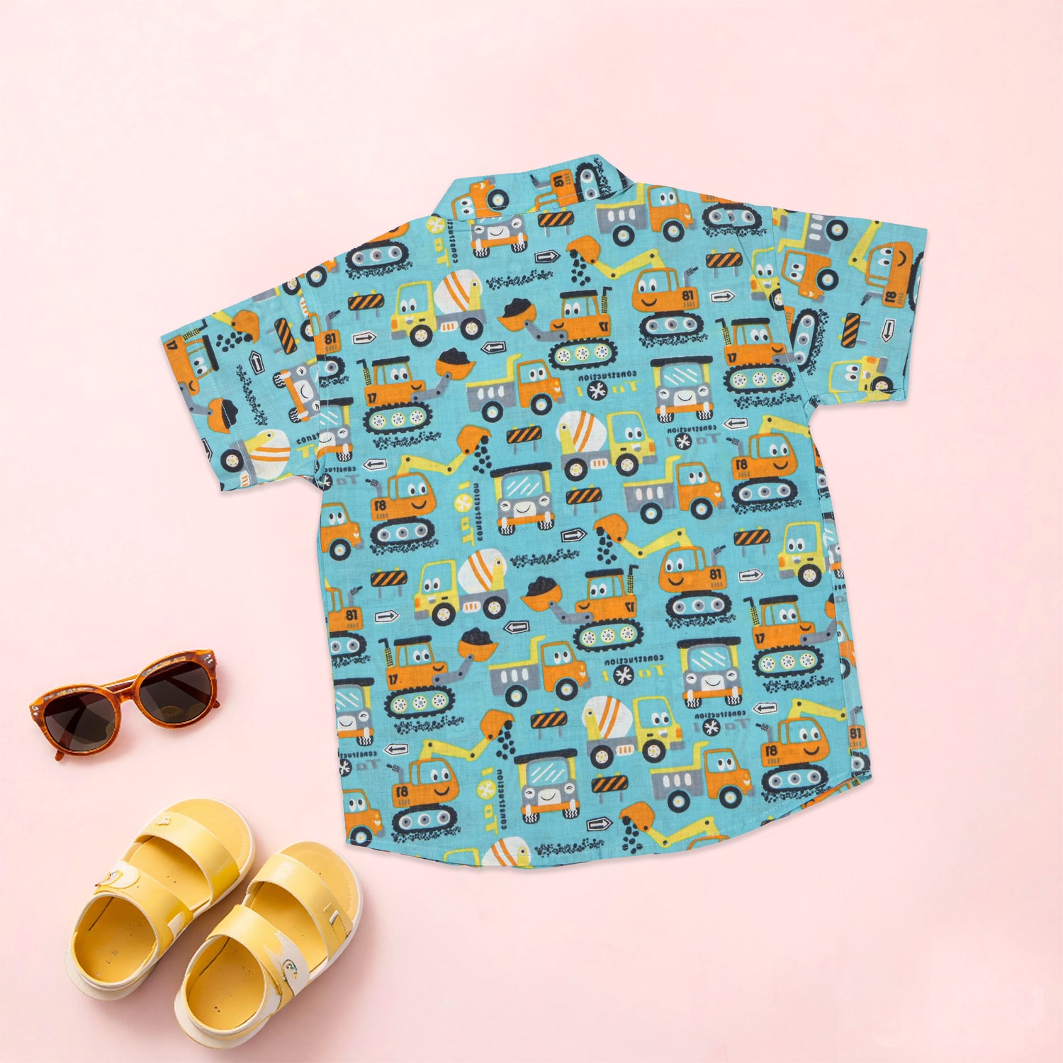 Boy wearing Aqua Truck print co-ord set with a printed shirt and shorts featuring a Chinese collar by Boon Babies.