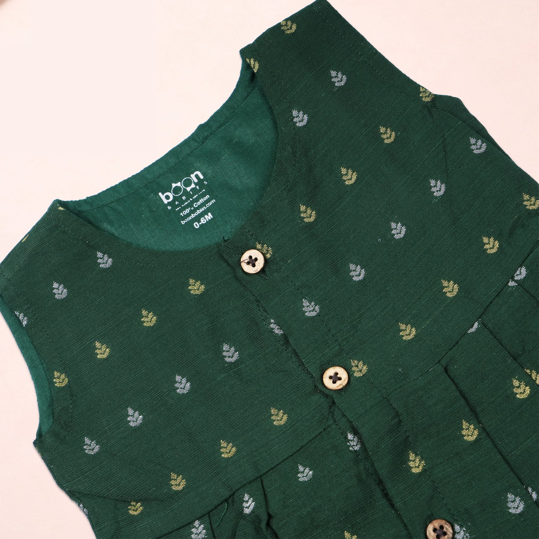 Green ethnic sleeveless frock for baby girls by Boon Babies, featuring traditional embroidery and comfortable fabric.