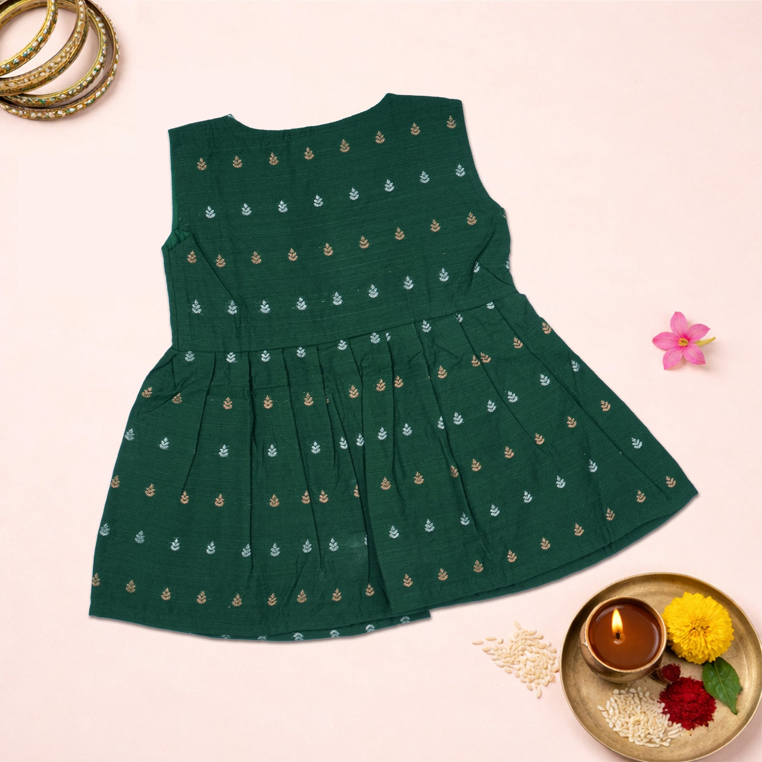Baby girl wearing a green ethnic sleeveless frock by Boon Babies, featuring traditional design and comfortable fabric.