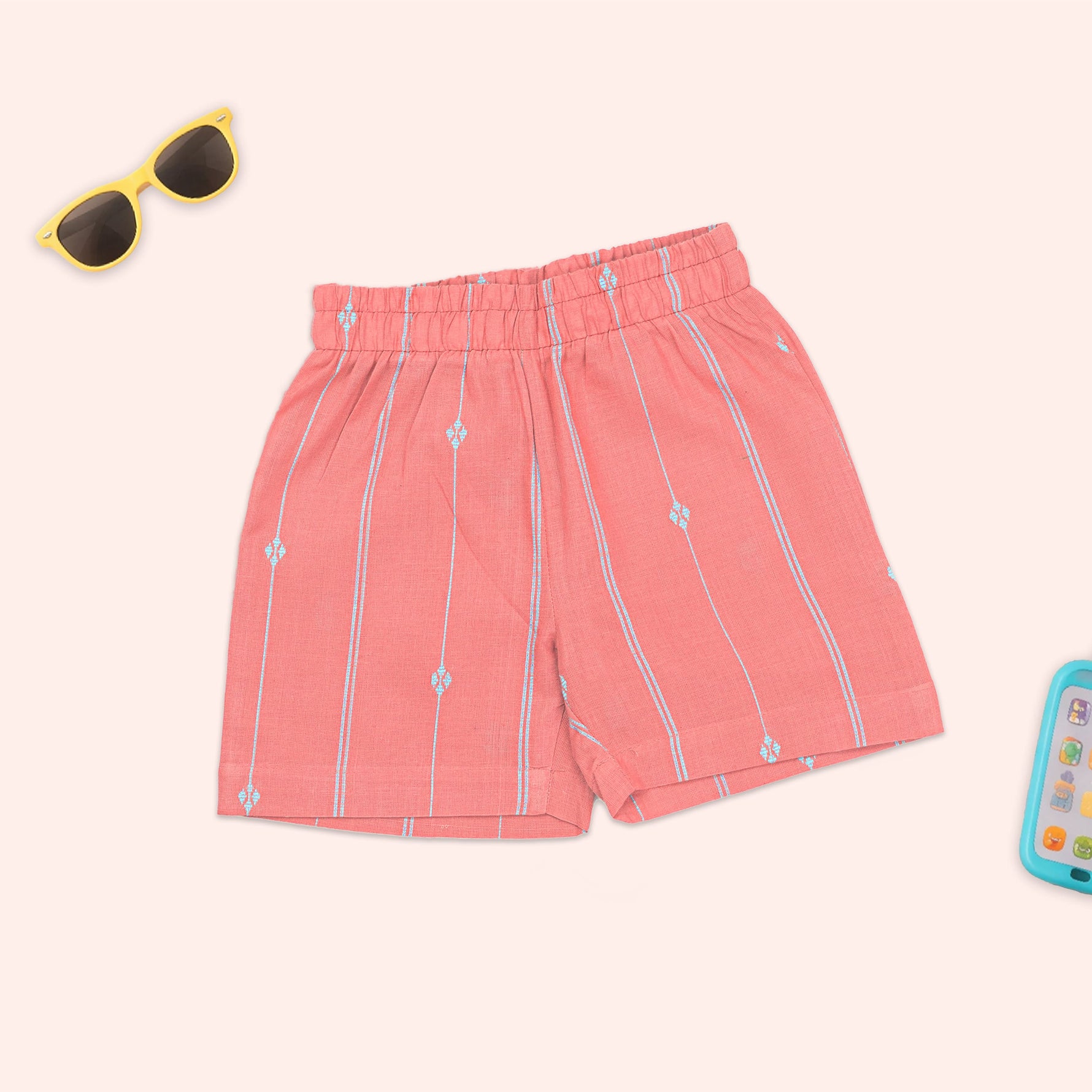 Boys teal and coral printed handloom cotton shirt and shorts set with straight collar, by Boon Babies, laid out flat.