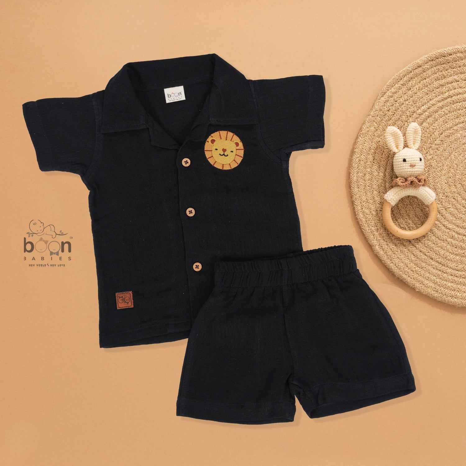 Black crinkle muslin shirt and shorts set for boys featuring lion face embroidery and wooden buttons – breathable toddler outfit by Boon Babies, Coimbatore.
