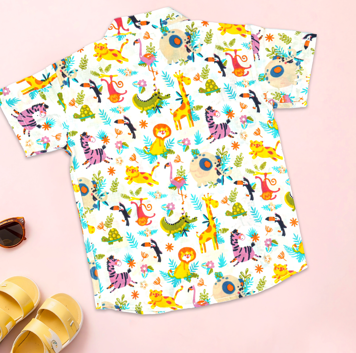 Boy wearing a jungle print co-ord set with a printed shirt and shorts with Chinese collar by Boon Babies.