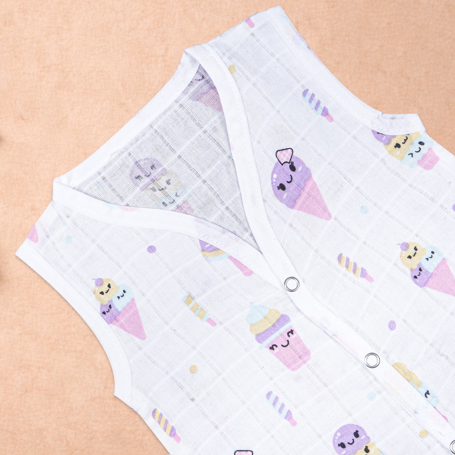Baby wearing a soft, breathable printed muslin jabla for infants 0-12 months, featuring a comfortable sleeveless design.