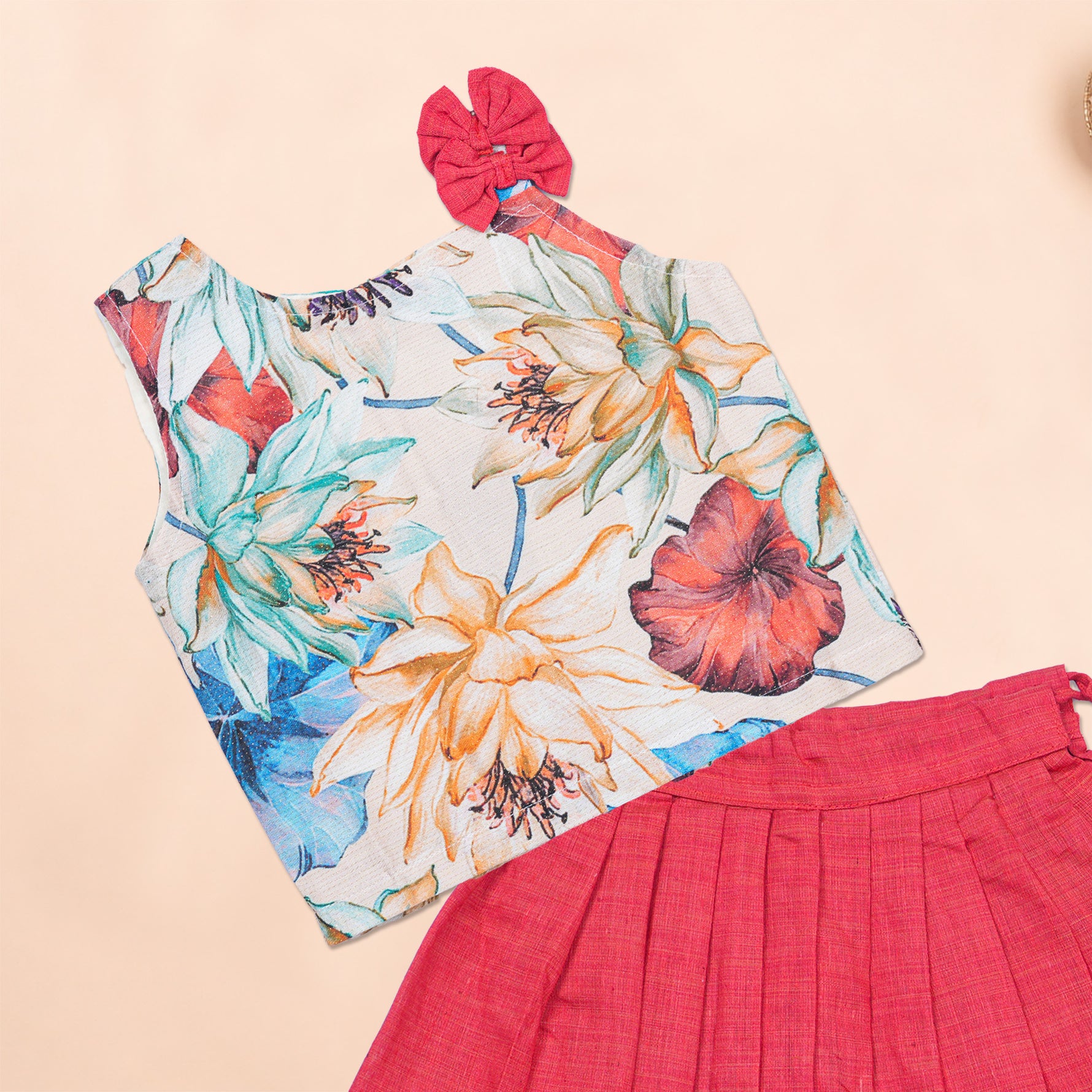 Girls floral pink ethnic top and pleated skirt set by Boon Babies, featuring a colorful floral design and matching pleated skirt.