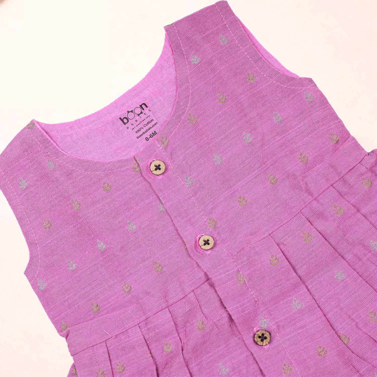 Baby girl in a pink ethnic sleeveless frock by Boon Babies, showcasing intricate embroidery and traditional design.