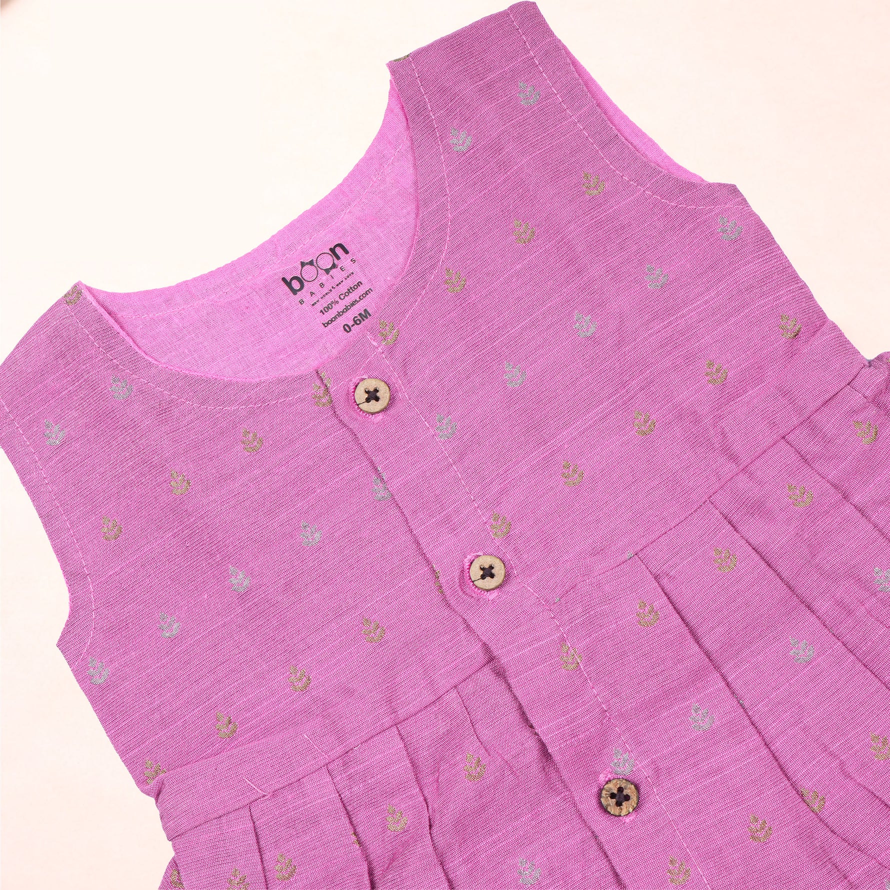Baby girl in a pink ethnic sleeveless frock by Boon Babies, showcasing intricate embroidery and traditional design.