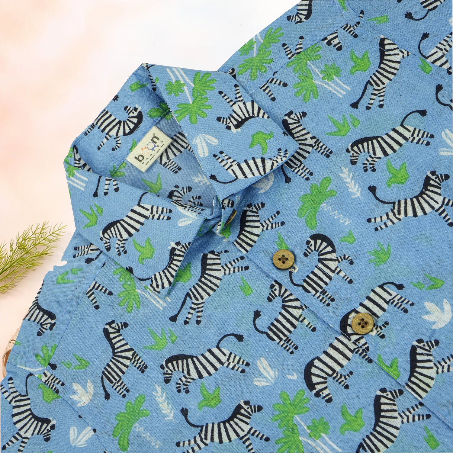 Boy wearing Boon Babies Jaipur cotton zebra print shirt and shorts with straight collar, summer casual wear.