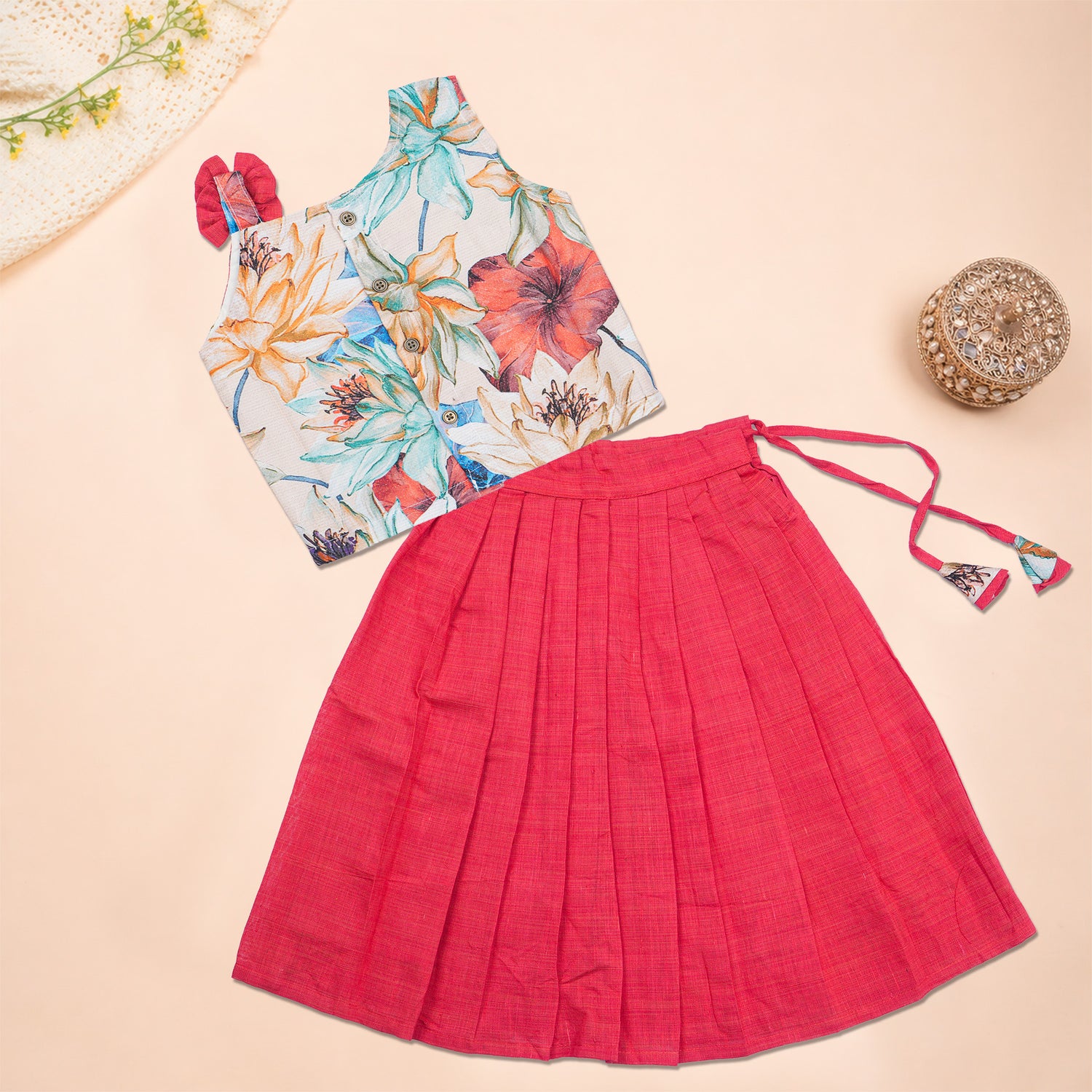 Girls floral pink ethnic top and pleated skirt set by Boon Babies, featuring vibrant floral patterns and comfortable fabrics.