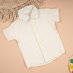 Boy wearing Boon Babies solid popcorn shirt with regular collar, lightweight polycotton casual shirt for kids aged 6 months to 5 years.