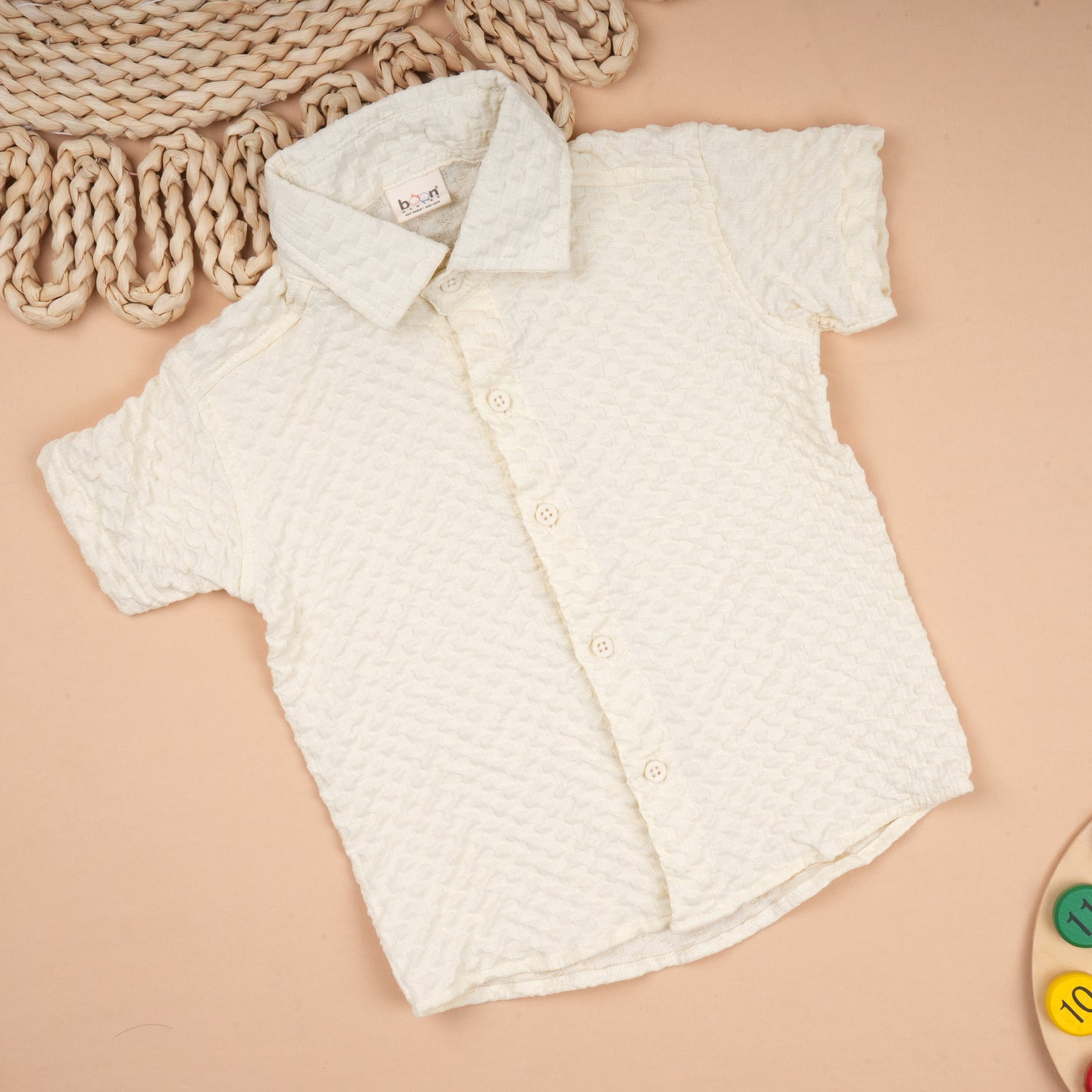 Boy wearing Boon Babies solid popcorn shirt with regular collar, lightweight polycotton casual shirt for kids aged 6 months to 5 years.