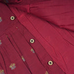 Baby girl wearing a red ethnic sleeveless frock by Boon Babies, featuring traditional embroidery and a comfortable fit.