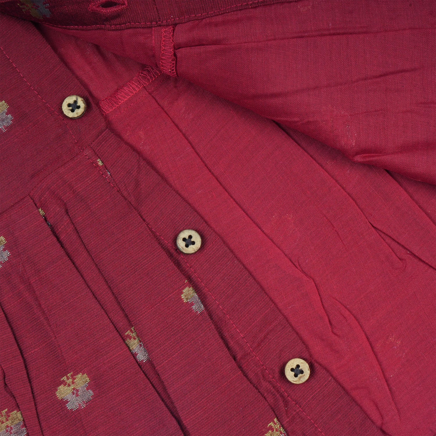 Baby girl wearing a red ethnic sleeveless frock by Boon Babies, featuring traditional embroidery and a comfortable fit.
