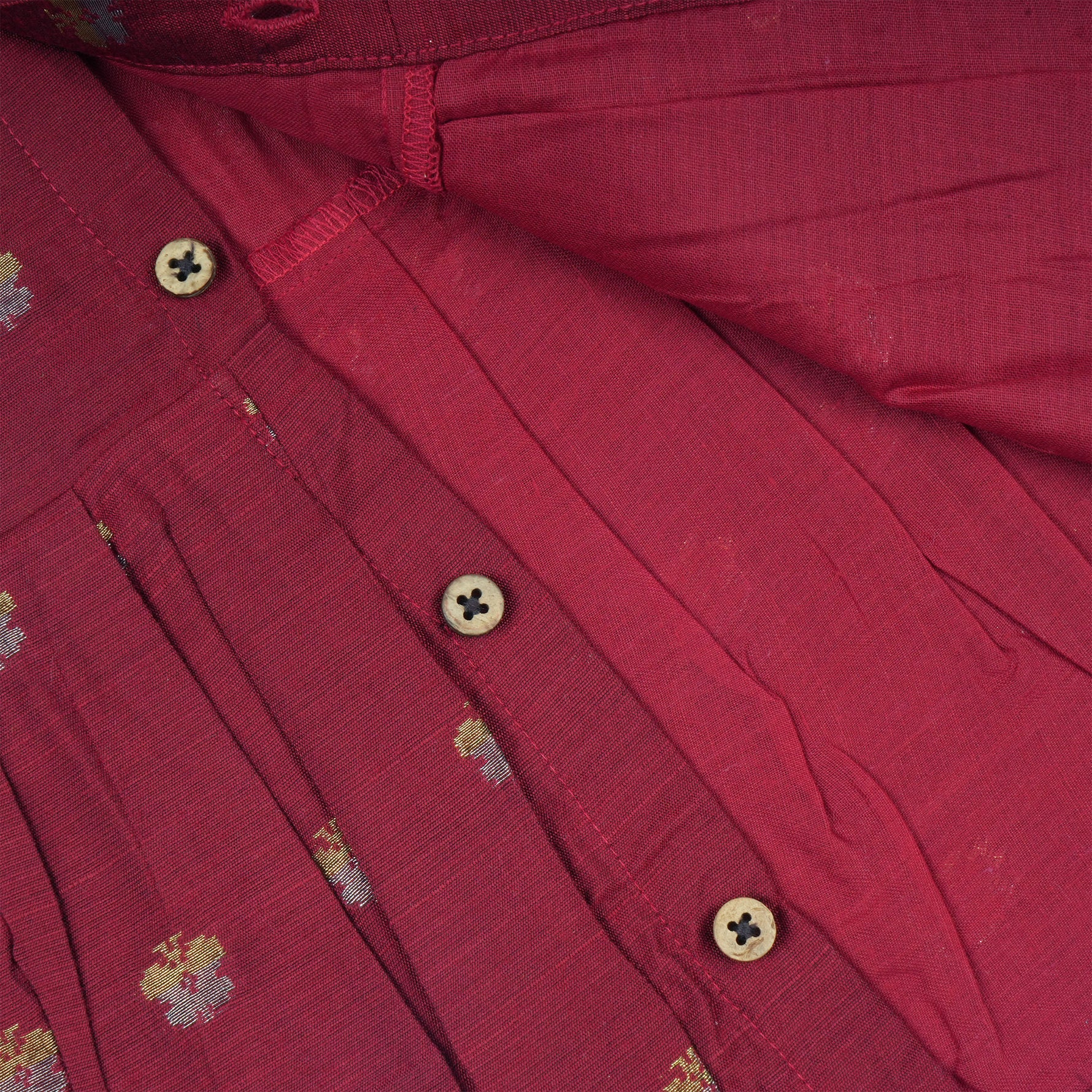 Baby girl wearing a red ethnic sleeveless frock by Boon Babies, featuring traditional embroidery and a comfortable fit.