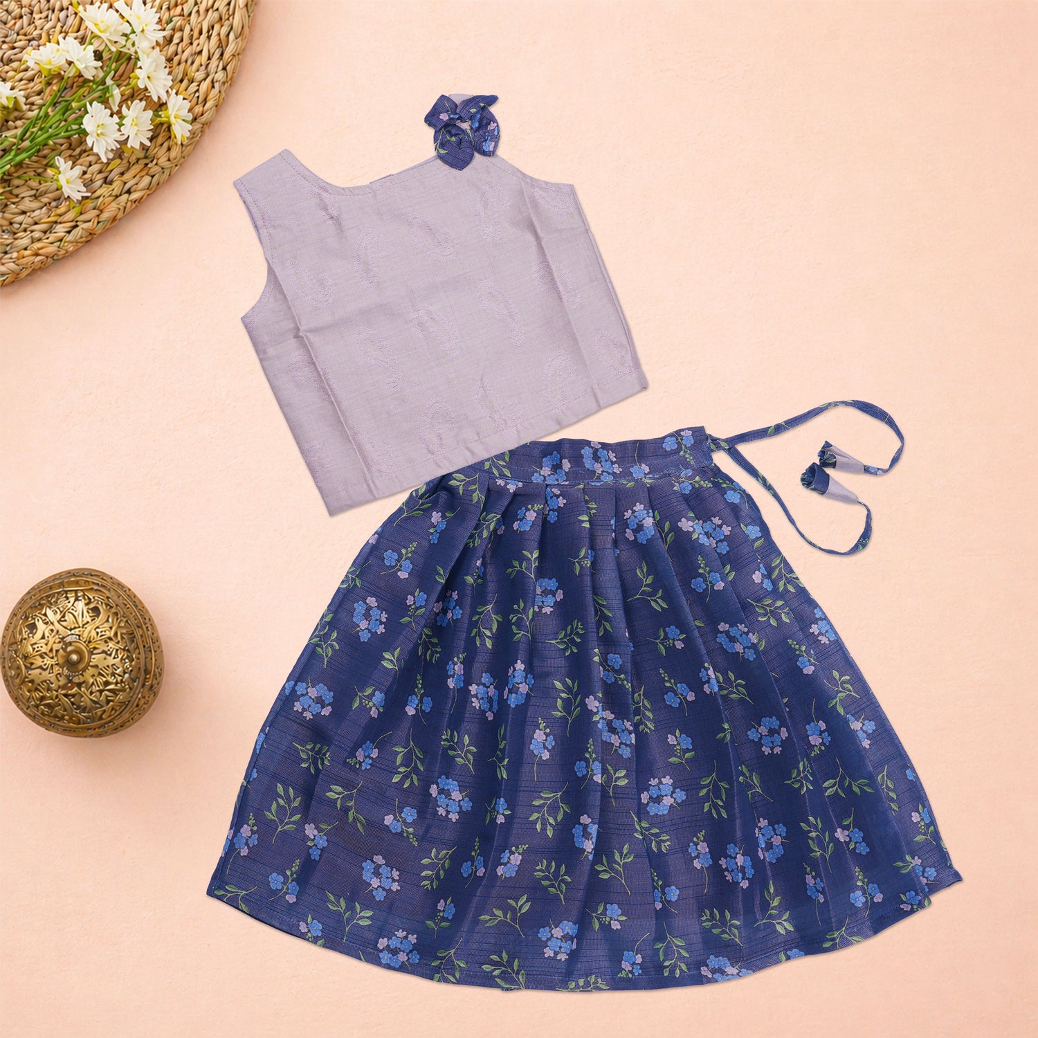 Girls lavender ethnic top and floral pleated skirt set by Boon Babies, featuring a lavender top with floral accents and a matching pleated skirt.