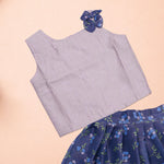 Girls lavender ethnic top and floral pleated skirt set by Boon Babies, featuring a lavender top paired with a colorful floral skirt.