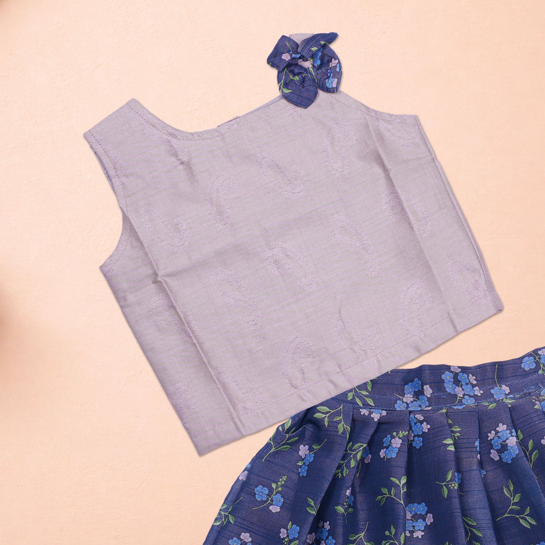 Girls lavender ethnic top and floral pleated skirt set by Boon Babies, featuring a lavender top paired with a colorful floral skirt.