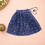 Girls lavender ethnic top and floral pleated skirt set by Boon Babies, featuring a matching lavender top and colorful pleated skirt.
